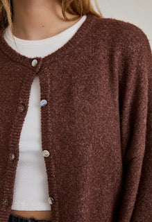 Brown cardigan worn by a person with a neutral background